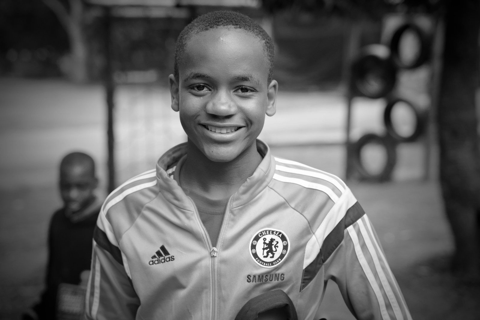 A young boy smiles at the camera.